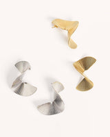 House of Holabox Obus Moonsong earrings in platinum and gold with a sculptural, pleated, and curved metallic design.