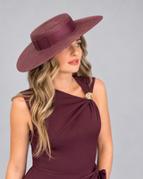 House of Holabox Morgan & Taylor dark cherry red boater hat with ribbon trim worn by a woman in a matching dress