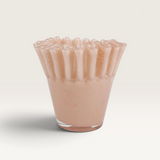 House of Holabox Ben David Soy Kiki candle in Nude Velvet, featuring a ruffled glass vessel in a soft pink hue.