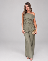 Model wearing House of Holabox olive green cotton-linen Imogen pant set with drop-shoulder top and tailored trousers.
