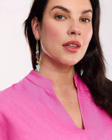 House of Holabox Pacifica drop earrings featuring gold starfish, turquoise, coral, and pearl beads on a model