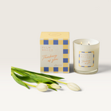 House of Holabox Palm Beach Collection Thinking of You soy candle with two wicks and white tulips on a light background