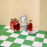 House of Holabox Jones & Co Pepe Dolce ceramic cups with whimsical lolly and lemon illustrations on a checkered table