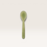 House of Holabox Kip resin spoon in a soft pesto green colour with a smooth, marbled finish for serving.