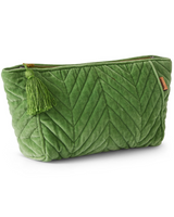 House of Holabox pesto green velvet toiletry bag with chevron quilting, zip closure, and a decorative tassel.