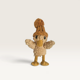 House of Holabox Mini Petunia Duck plush toy wearing a knitted brown pom-pom hat and yellow corduroy legs.
