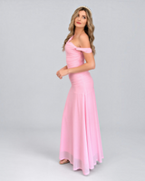 Model wearing a House of Holabox pink mesh maxi dress with a ruched bodice and one-shoulder cold shoulder neckline.