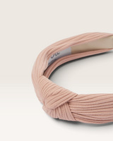 House of Holabox Izoa Manhattan headband in pink ribbed fabric with a stylish top knot detail.