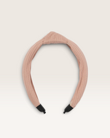 House of Holabox Izoa Manhattan pink ribbed fabric headband featuring a statement top knot detail.