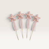 House of Holabox Alimrose star-shaped wands covered in pink sequins with delicate fabric ribbons for dress-up play.