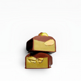House of Holabox Pistachio Mylk Praline chocolate halves showing a smooth green ganache filling with pistachio pieces