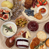 House of Holabox The Peel Thing quince paste jars served on a grazing board with cheese, crackers, and fresh fruit.