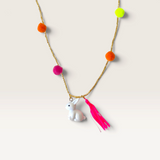 House of Holabox rabbit pom pom necklace featuring a white bunny charm, neon pink tassel, and colorful pom poms.