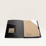 House of Holabox A5 recycled leather journal open to show spiral bound notepad, inner pocket, and pen loop.