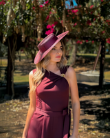 House of Holabox Morgan & Taylor dark cherry red boater hat with ribbon trim worn by a woman in a matching dress