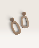 House of Holabox Riley dangle earrings featuring a minimalist organic taupe acrylic shape and surgical steel posts.
