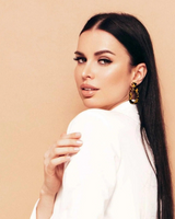 House of Holabox Riley dangle earrings featuring a tortoiseshell acrylic organic shape worn by a woman in white