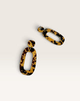 House of Holabox Riley dangle earrings featuring a modern organic oval shape in a brown and tan tortoiseshell pattern.