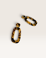 House of Holabox Riley dangle earrings featuring a modern organic oval shape in a brown and tan tortoiseshell pattern.