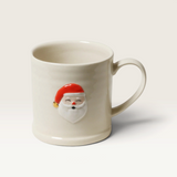 House of Holabox Robert Gordon stoneware mug featuring a hand-painted Santa motif on a cream background.