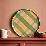 House of Holabox Robert Gordon stoneware cake plate featuring a cinnamon and green check pattern on a shelf.