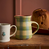 House of Holabox Robert Gordon stoneware jug featuring a green and cream check pattern on a rustic wooden table