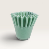 House of Holabox Ben David Soy Kiki candle in a sage green ruffled glass vessel