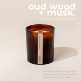 House of Holabox saide. large amber glass soy candle with a wood wick and clove and sandalwood label