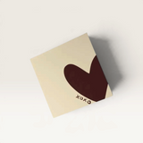 House of Holabox recycled paper greeting card with a dark brown heart and XOXO text on a cream background
