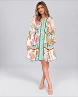 House of Holabox Sara mini event dress in yellow floral cotton with V-neck, billowing sleeves, and waist tie