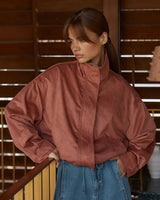 House of Holabox Sara Suede Bomber Jacket in rust with silver snap detailing and elasticated hem.