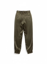 House of Holabox Satin Moment Pant in pesto green with a high-rise waist, blouson leg, and cuffed ankles.