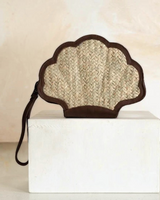 House of Holabox Odette shell-shaped clutch in natural woven straw with brown leather trim and wrist strap