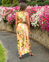 House of Holabox Sheree high neck maxi dress with painterly floral print in peach and green, back view.