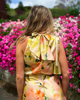 House of Holabox Sheree maxi dress featuring a high neck, back bow detail, and painterly floral print in soft tones.