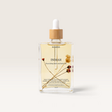 House of Holabox Soaked Body Bar Indiah nourishing bath and body oil in a glass bottle with dried botanicals