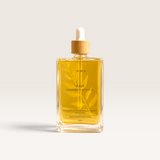 House of Holabox Soaked Body Bar Rain nourishing bath and body oil in a 100ml glass bottle with a wooden dropper lid.