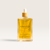 House of Holabox Soaked Body Bar Summer Sunset nourishing bath and body oil in a glass bottle with a wooden dropper.