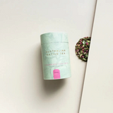 House of Holabox Strawberry Gum green tea in a light green canister with loose leaf tea and cornflower petals.