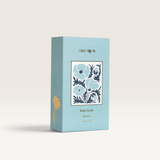 House of Holabox Stray Willow Blue Tansy body scrub in a light blue rectangular box with floral botanical illustration