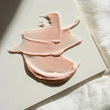 Facial mask in a soft peach-pink clay texture, featuring smooth creamy swirls. Stray Willow Peach Tea formula