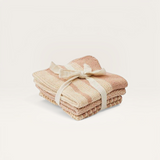 House of Holabox Amy knit cloths in soft pink and cream stripes, tied with a ribbon for a rustic kitchen aesthetic.