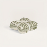 House of Holabox Amy knit kitchen cloths in sage green and cream stripes, tied with a ribbon.