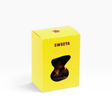 House of Holabox Sweeta milk chocolate covered macadamia nuts in a bright yellow box with a cutout window