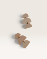 House of Holabox Izzy dangle earrings in matte taupe acrylic with a sculptural geometric design and gold accents.