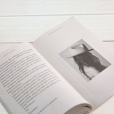 House of Holabox book The Art Of Who We Are by Robert W. Dean open to a page with a black and white photo of a hat