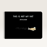 House of Holabox board book This Is Not My Hat by Jon Klassen featuring a tiny fish wearing a blue hat on black