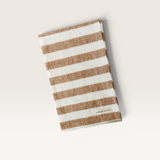 House of Holabox Mama and Tochter French linen tea towel featuring a wide toffee brown and cream striped pattern.
