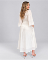 House of Holabox white cotton maxi dress with bell sleeves and lace trim, back view on a model