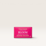 House of Holabox Wild Emery Bloom shower steamer in a bright pink box with rose geranium and palmarosa scent.